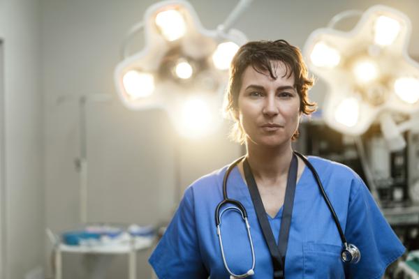 Surgeon looking into camera in an operating theatre