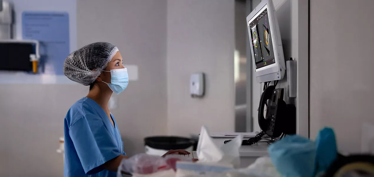 Health care professional looking at display in a lab setting