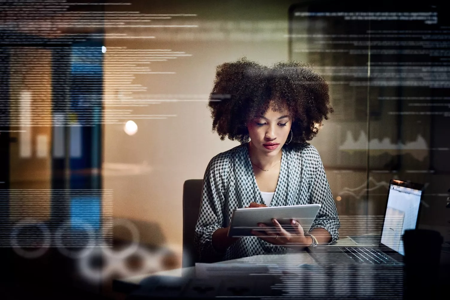 Woman looking down at a tablet screen.