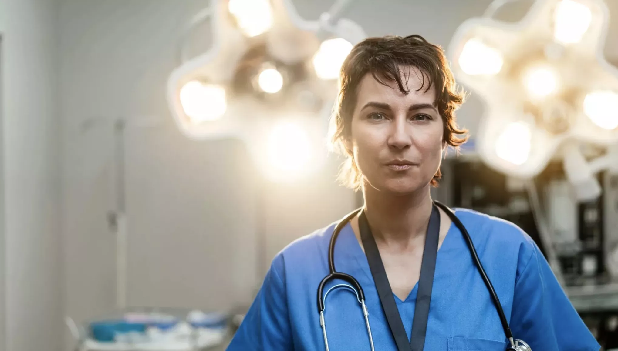 Surgeon looking into camera in an operating theatre