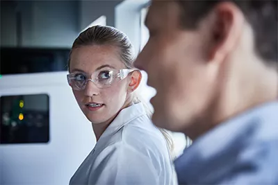 Woman and man talking in lab